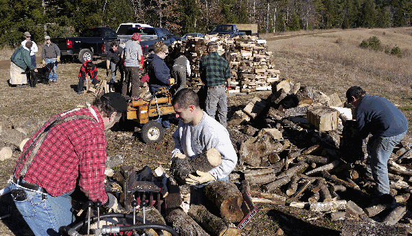 group of people cutting wood
